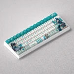 Gallery view of the exclusive Valorant Sage PBT keycap set, revealing its premium design, iconic green hues, and healing motifs from various angles.