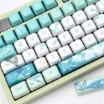 Venti Anemo Whimsy FOA PBT keycaps set, angled to reveal ethereal teal, white, gold dye-sub. Whimsical wind and lyre motifs for Genshin Impact.