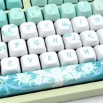 Venti Anemo Whimsy FOA PBT Keycap Set: Exclusive Venti-inspired design featuring ethereal teal, white, gold, whimsical wind and lyre motifs.