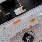 White Orange Mist Cherry Keycap Set, artfully displayed from multiple angles, highlighting the white and orange aesthetic.