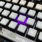 Exquisite Jiangnan Wuxia ink wash art PBT pudding keycaps set displayed from multiple angles, showcasing the traditional Chinese landscape and martial art.