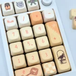 Close-up of exclusive Xia Yan Tears of Themis PBT keycaps set, showcasing sophisticated character art and cool-toned elegance from multiple perspectives.