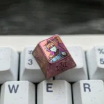 Showcasing the exclusive Yinlin titanium anime ESC keycap from multiple angles, revealing its intricate character design and vibrant metallic finish.