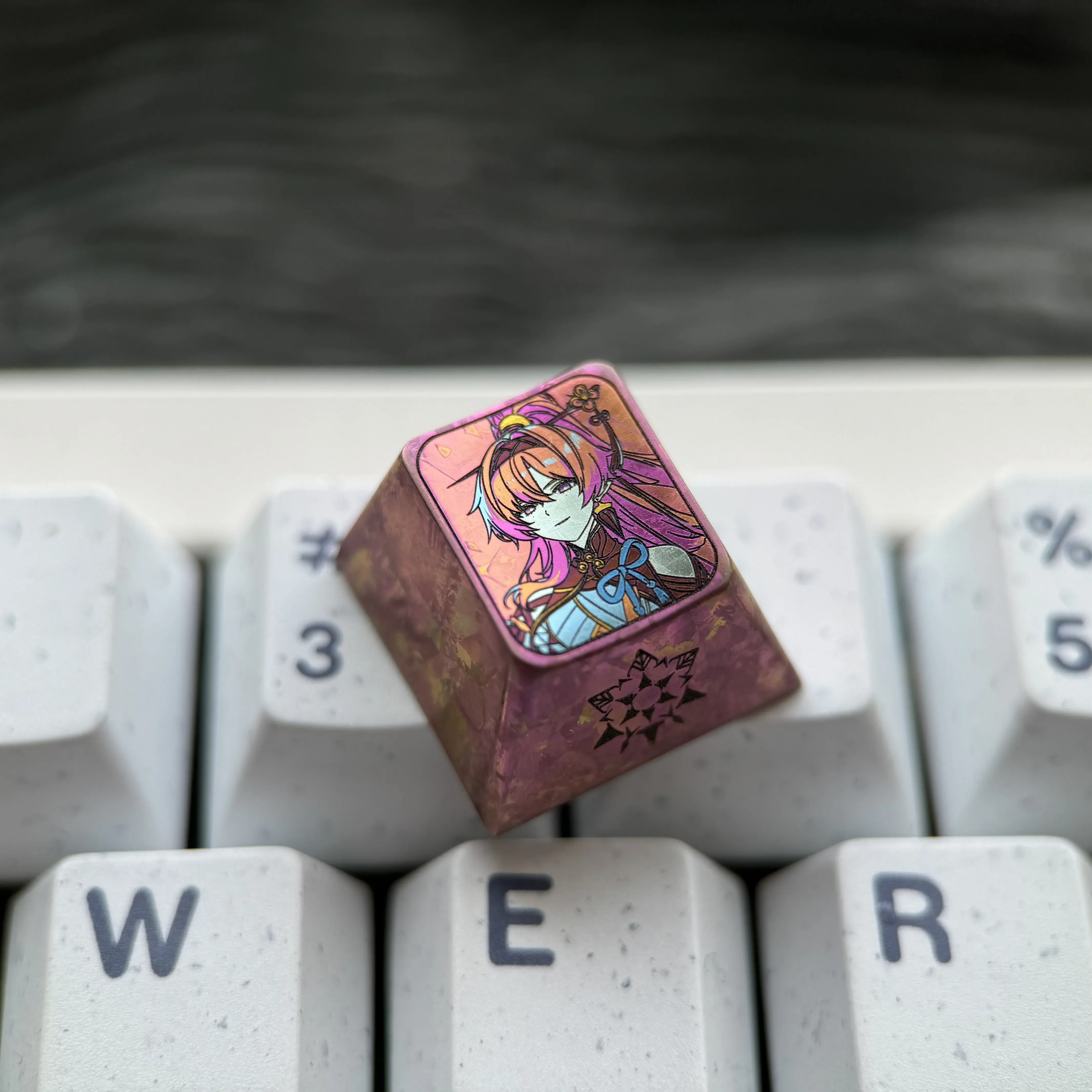 Showcasing the exclusive Yinlin titanium anime ESC keycap from multiple angles, revealing its intricate character design and vibrant metallic finish.