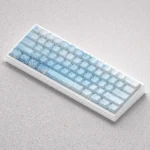 Multiple views of the Ethereal Yuki-onna PBT keycap set, showcasing delicate art and icy blue and white themes inspired by Japanese folklore.