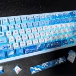 Zayne Keycap Set: elegant double-shot PBT set. Gallery views highlight the exclusive side-engraved legends and character-inspired aesthetic from multiple angles.