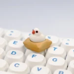 Another view of the exquisite handcrafted 3D artisan Java Sparrow keycap, revealing the intricate miniature bird scene and textured mat. Highlights its artistic design.