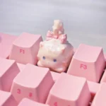 Close-up views of the whimsical fluffy cat artisan keycap from various angles, highlighting its unique handcrafted details and warm white tones.