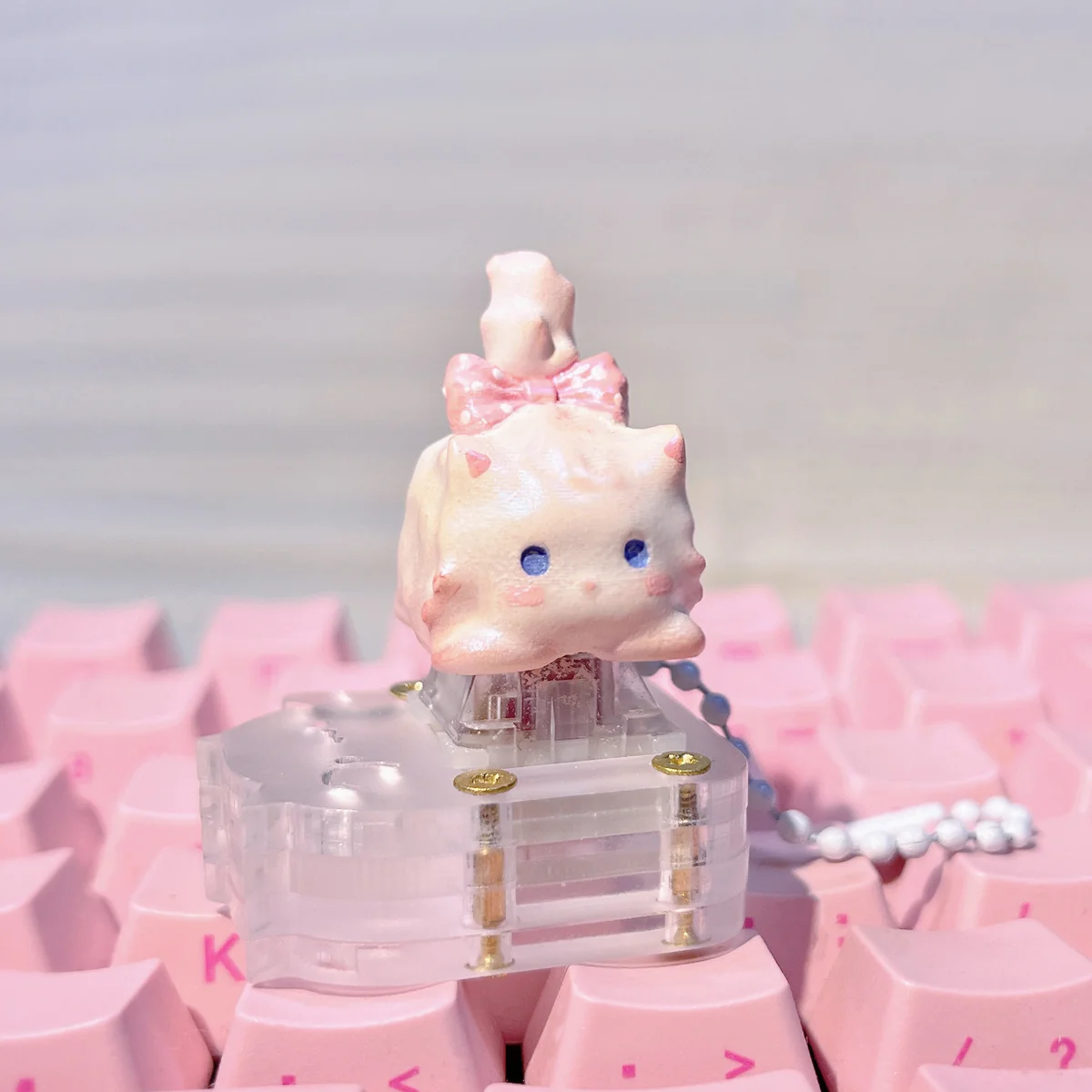 Whimsical fluffy cat artisan keycap, revealing its unique handcrafted details, warm white tones, and charm from various perspectives.