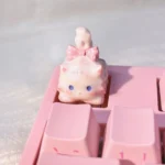 Showcasing different angles of the whimsical fluffy cat artisan keycap with intricate details and warm white tones, highlighting its unique charm setup.
