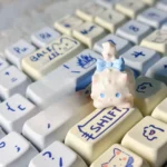 Gallery of the whimsical Fluffy Cat Artisan Keycap, showcasing its unique design, intricate details, and warm white tones from multiple angles.