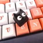 Whimsical Little Black Cat artisan resin ESC keycap from various angles, highlighting its translucent material, intricate handmade details, and unique charm.