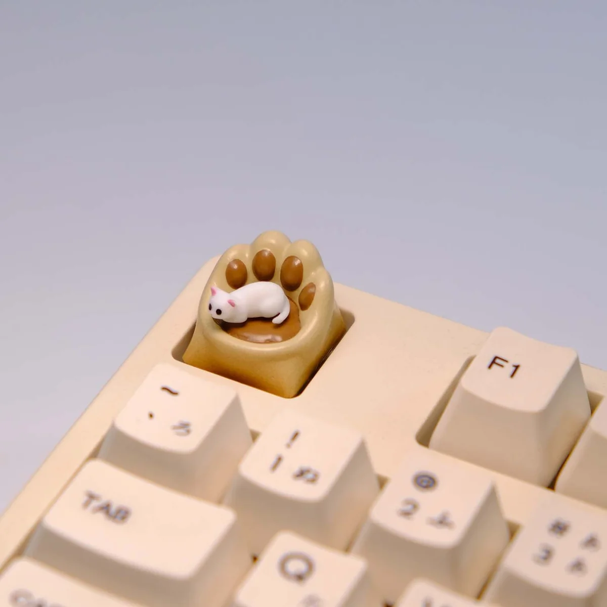 Whimsical handcrafted magnetic 3D Cat Paw Sofa Artisan Keycaps in various views, showing the playful miniature white cat with blue eyes on its cozy sofa.