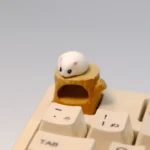 Handmade magnetic hamster artisan keycap, featuring the adorable, detachable hamster sitting cozily on its detailed woodland stump.