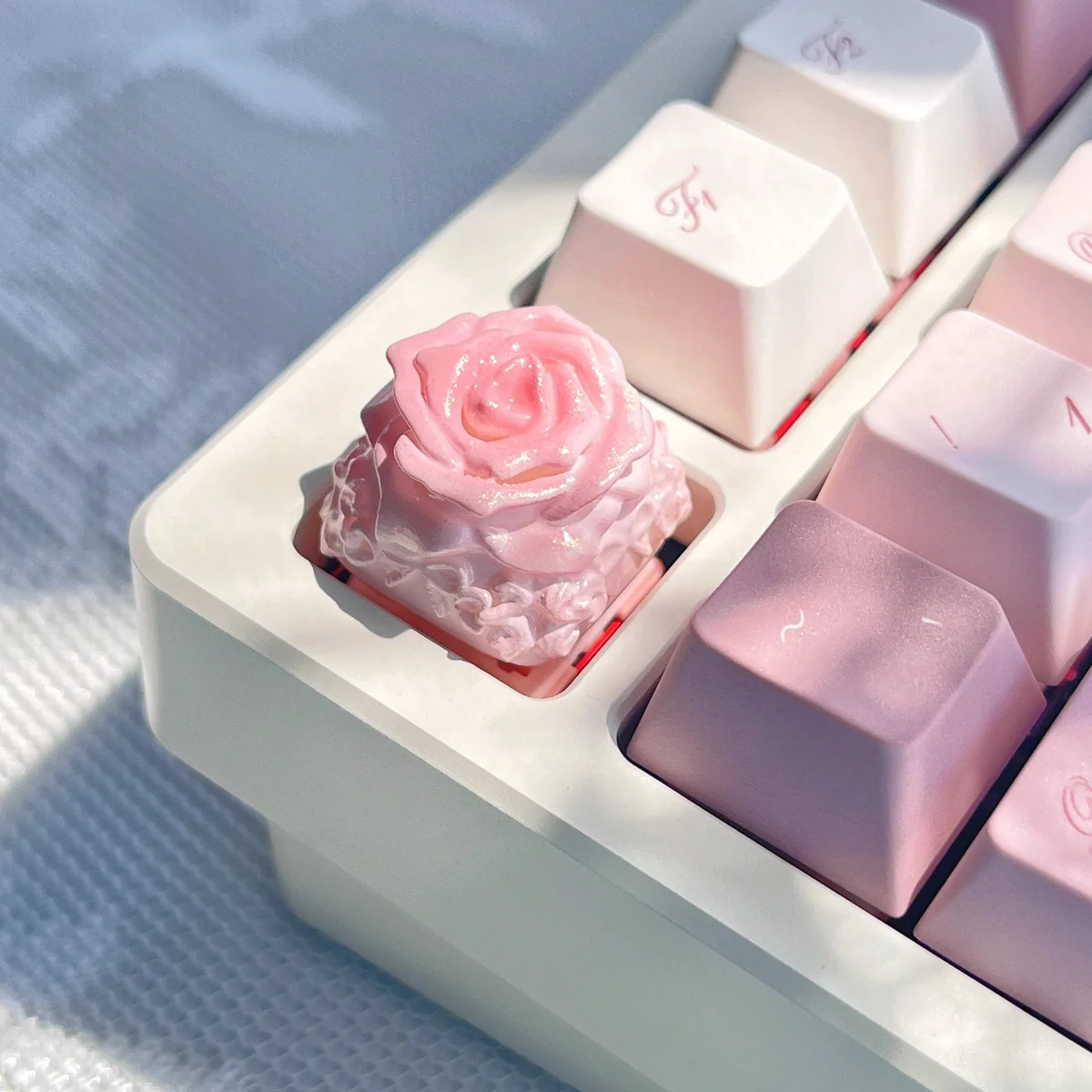 Detailed shot of an exquisite handcrafted rose artisan keycap, revealing the delicate resin rose's intricate petals and artistic clear finish.
