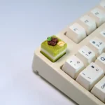 Handcrafted mousse cake artisan keycap from multiple angles, showcasing unique whimsical dessert design, vibrant pastel colors, and realistic texture.