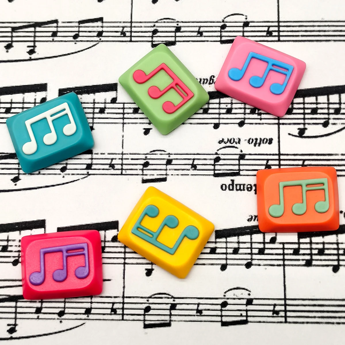 Vibrant handcrafted Musical Note Low Shaft Keycaps featuring fluid dual-tone music notes, artistically displayed from multiple angles to highlight exquisite design.