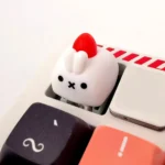 Whimsical artisan rabbit ESC keycap, handcrafted with a charming strawberry design. Multiple angles reveal its tactile texture and intricate details.