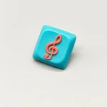 Handcrafted Treble Clef Low Shaft Keycaps featuring a vibrant treble clef on a playful blue resin base, perfect for MX keyboards.