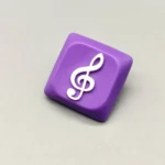 Treble Clef Low Shaft Keycaps featuring a glossy treble clef on a purple resin base.