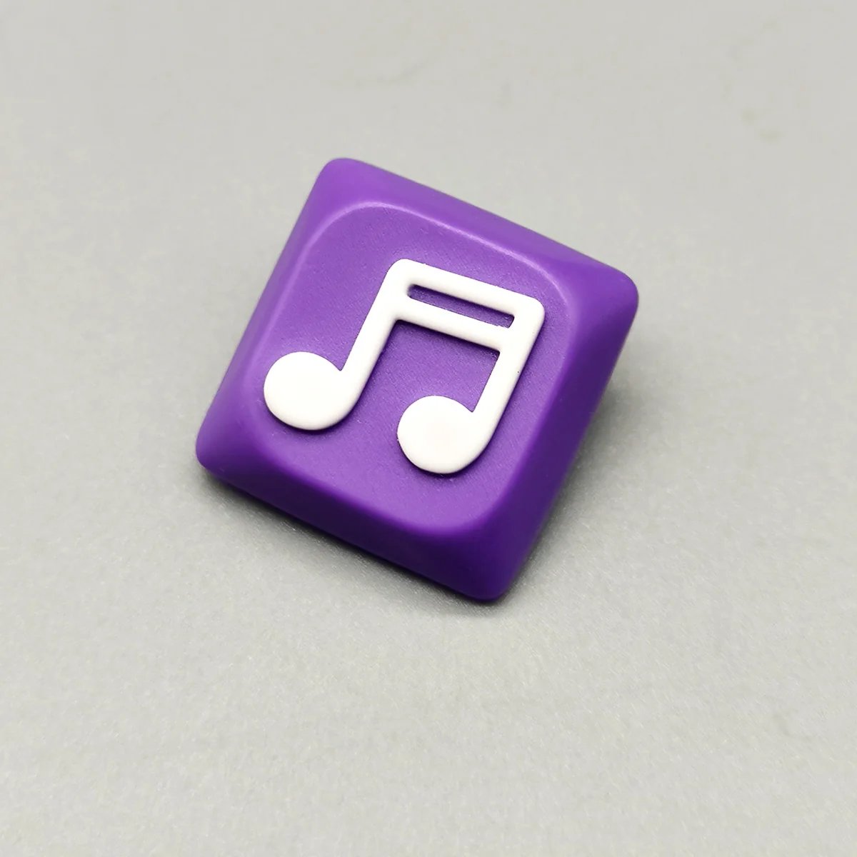 Handcrafted Two Beam Eighth Note Symbol Keycaps with a vibrant purple resin base embedding a musical rhythm symbol.