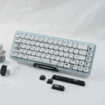 Close-up of PBT MOA astronaut keycaps set, revealing cosmic artistry with stylized astronauts and deep space hues. Durable, ergonomic design enhances celestial.