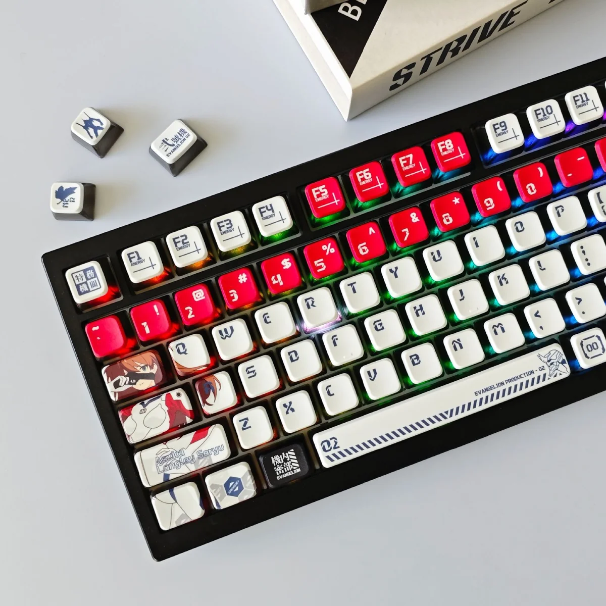 Playful Asuka Pudding RGB keycaps set from the EVA Anime Set. Multiple angles reveal iconic Asuka designs, translucent pudding sides, and sharp legends.