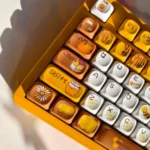 Vibrant PBT dye-sub bee keycaps set showcase charming bee, honeycomb, and flower motifs from various angles, bringing honeycomb joy.