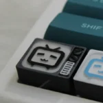 Handcrafted BiliBili Pixel TV keycap views, showing intricate translucent resin art with retro pixel detail and backlit Bilibili logo from various angles.