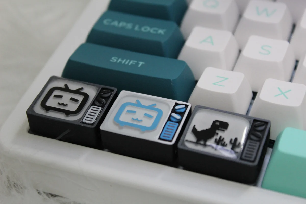 Stunning handcrafted resin BiliBili Keycaps featuring a miniature retro pixel TV with a visible Bilibili logo, designed for backlit keyboards.