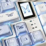 Ethereal Blue Butterfly Keycap Set: Rose Shadow KDA Profile. Exquisite blue butterfly, rose shadow. Multiple angles reveal intricate, dreamlike floral details.