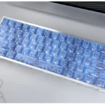 A gallery of exclusive blue forged carbon keycaps set, showcasing their dynamic texture, sleek modern design, and precision side-printed legends from various angles.