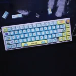 Multiple views of whimsical Bugcat Capoo PBT dye-sub keycaps set, showcasing vibrant blue and pastel cartoon characters with a durable, premium finish.
