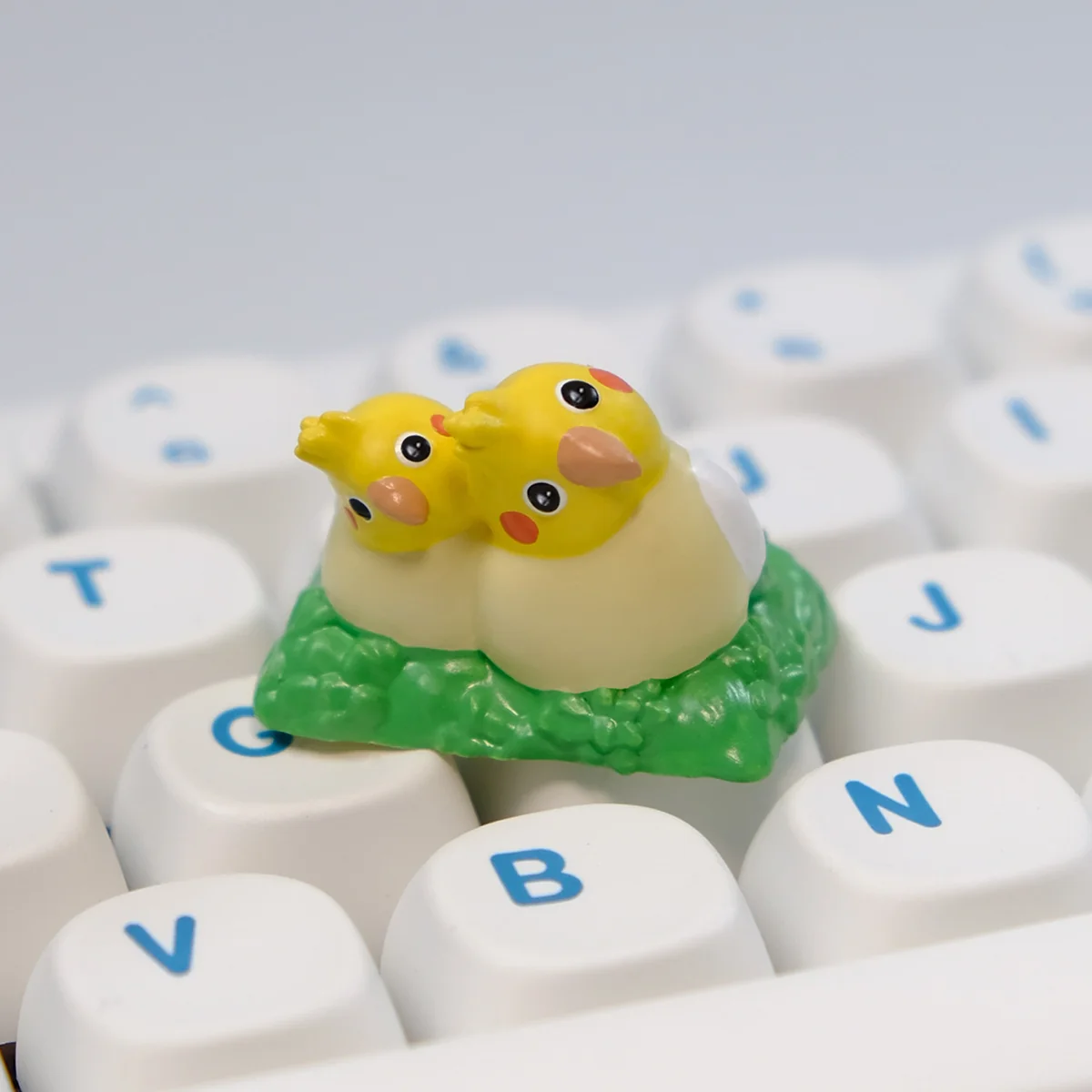 Adorable handcrafted 3D Whimsical Bushes Couple Cockatiel artisan keycap, intricately sculpted with charming nature elements.