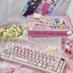 A gallery of iconic Cardcaptor Sakura PBT dye-sub keycaps set, showcasing whimsical pastel pink and purple designs with magical anime motifs. Each angle hidden characters design.