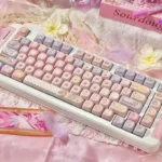 Iconic Cardcaptor Sakura PBT dye-sub keycaps set in a playful arrangement, showcasing whimsical pastel pink and purple magical anime motifs from a fresh aesthetics.