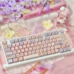 Whimsical Cardcaptor Sakura PBT dye-sub keycaps set in pastel pink and purple MOA profile, beautifully boxed with a keycap puller.