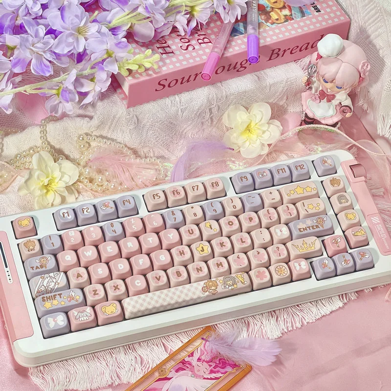 Iconic Cardcaptor Sakura PBT dye-sub keycaps set showcasing whimsical pastel pink and purple magical anime motifs.