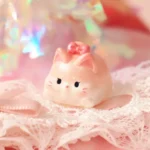 Gallery of a handcrafted adorable sweet cat artisan keycap, showing its charming pastel design and intricate details from various playful angles.