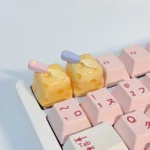 Whimsical handcrafted cheesecake keycap, a miniature realistic dessert with a playful fork. Adorable premium artisan accessory.