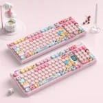 Detailed shots of the nostalgic Chibi Maruko-chan PBT keycap set, highlighting playful characters and the unique MOA profile from multiple perspective angles.