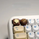 A delightful, handcrafted artisan chocolate biscuit keycap for custom keyboards, showcasing realistic 3D designs and rich brown hues.
