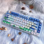 Festive blue PBT Christmas keycaps set, showcasing durable PBT keycaps with charming winter wonderland icons and a cozy, artistic aesthetic.