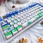 Festive Blue PBT Christmas keycaps set, featuring durable PBT material, charming blue and white winter wonderland icons, and a cozy aesthetic.