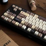 Coffee PBT keycaps set gallery displaying multiple angles, emphasizing their durable dye-sub PBT, warm coffee tones, and vintage Cherry profile.
