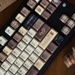 Collection of Coffee PBT Keycaps Set, highlighting the vintage Cherry profile and durable dye-sub PBT in warm coffee, cream, and dark brown tones from various angles.