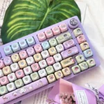 Playful Crayon Shin-chan PBT keycap set shown from multiple angles, highlighting its exclusive whimsical blue-purple anime aesthetic.