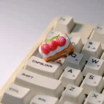 Artistic gallery views of the handcrafted Cream Raspberry Layer artisan TAB keycap, showcasing its intricate layers, sweet cream, and miniature design.