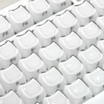 Close-up of translucent pastel Crystal Jelly MAO keycaps set featuring playful cat art and a sleek ergonomic profile, highlighting their double-layered depth.