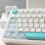 Premium designer keycap set, blending durable PBT and frosted PC for a modern aesthetic, shown from multiple angles. Highlights crisp, translucent design.